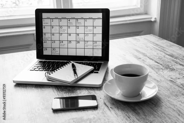 Fototapeta Checking monthly activities in the calendar in the laptop
