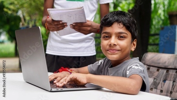 Obraz Indian School kids E-learning using laptop. Children doing homework at garden in computer.