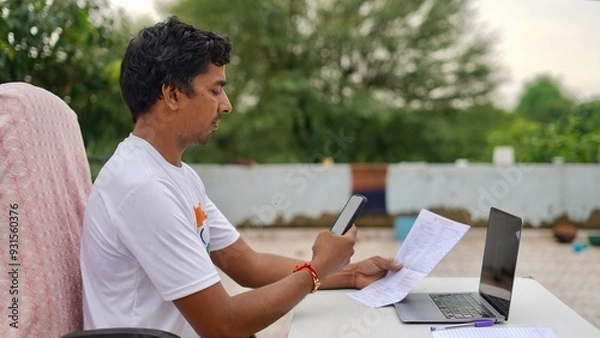 Obraz Indian young man doing payment with smartphone using QR code