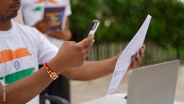 Obraz Indian young man doing payment with smartphone using QR code