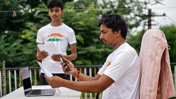 Obraz Indian young man doing payment with smartphone using QR code