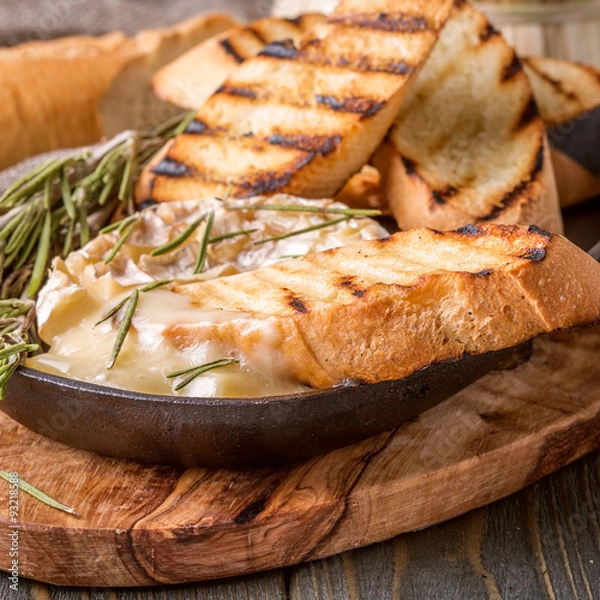 Obraz Homemade baked camembert with toasted bread and rosemary.