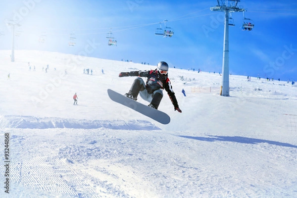 Obraz Snowboarder at jump inhigh mountains