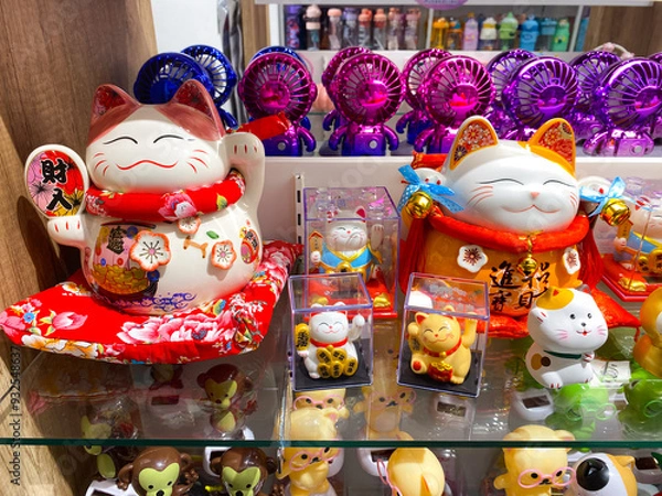 Fototapeta Display of Japanese Lucky Cat Figurines and Other Knick-Knacks