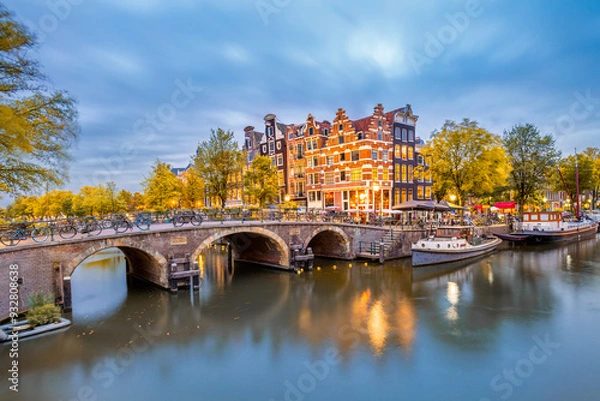 Fototapeta Autumn in Amsterdam, Netherlands. Panorama of the historic city center of Amsterdam. Traditional houses and bridges of Amsterdam small town.  Europe, Netherlands, Holland, Amsterdam.