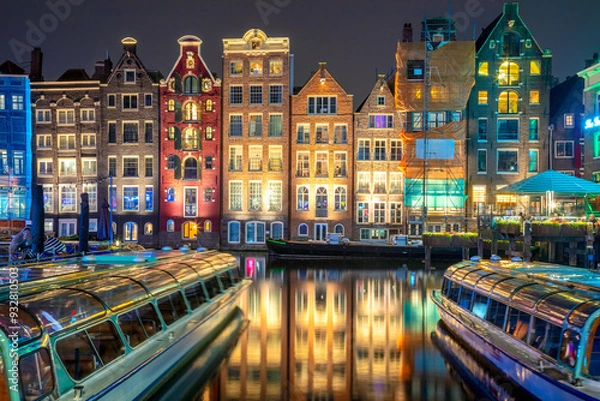 Fototapeta Old houses of Amsterdam. The houses stand in the water and have a beautiful reflection. Touristic district Damrak. These houses are famous all over the world. Amsterdam, Holland, Europe