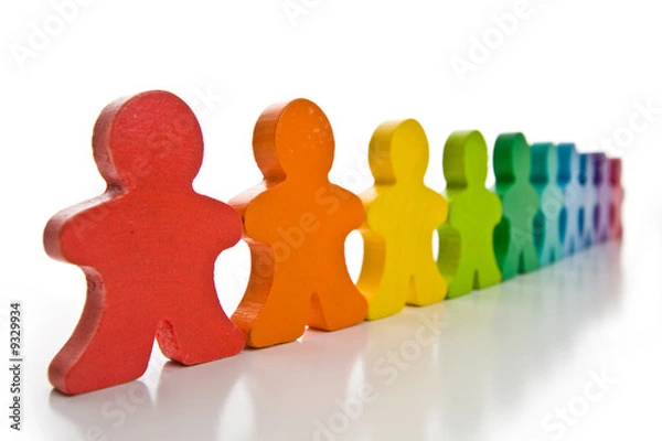 Obraz Brightly colored wooden people isolated on a white background.