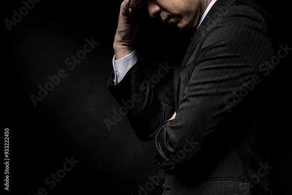 Fototapeta 頭を抱えて悩む男性