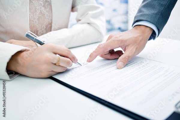 Obraz Female hand signing contract.