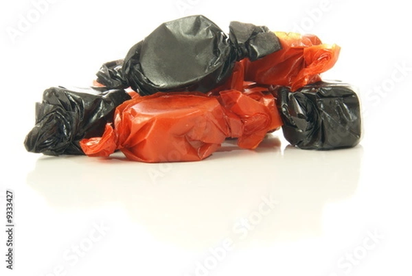 Fototapeta Black and Orange Halloween candy on white background