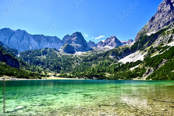Obraz A breathtaking alpine landscape featuring a crystal-clear emerald lake