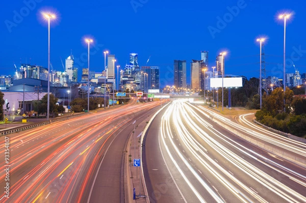 Fototapeta High speed traffic and light trails in highway at twilight