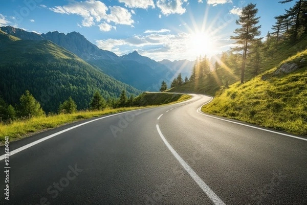 Obraz A winding road through a mountain landscape at sunrise with lush greenery and clear skies.