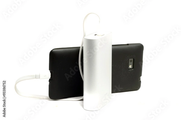 Fototapeta dusty mobile phone and an external battery on a white background