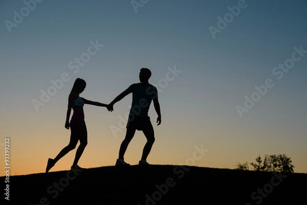 Obraz Tired athletes climb the mountain.