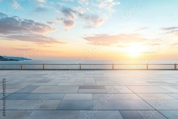 Fototapeta A serene coastal sunset over the ocean with a paved foreground.