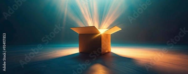 Obraz An open cardboard box emits radiant light beams in a dark, expansive setting, evoking themes of discovery, potential, and the unknown