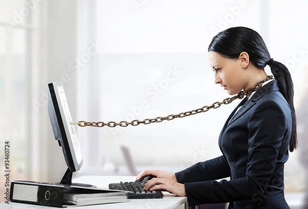 Obraz Female office worker chained to her computer