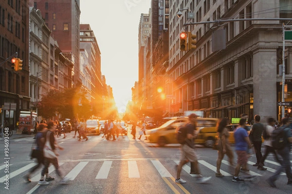 Fototapeta Busy intersection is crowded with people and cars at 5th Avenue and 23rd Street in New York City with sunset background