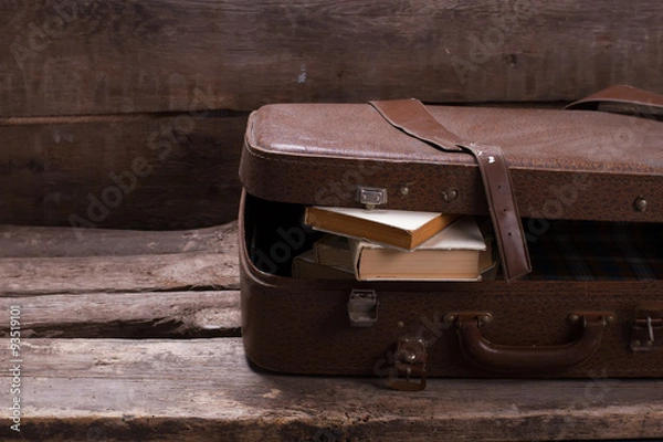 Obraz Old leather suitcase with books.