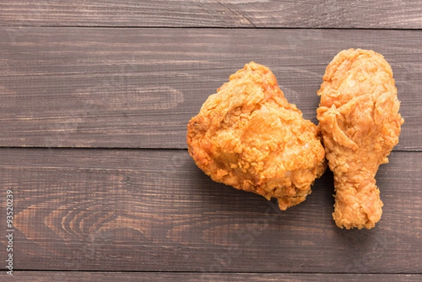 Obraz Fried chicken breast and chicken drumstick on a wooden background