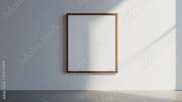 Fototapeta A single minimalist photo frame hanging on a blank white wall, with clean lines and simple elegance.