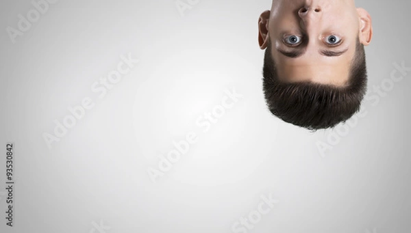 Obraz Thoughtful businessman watching curious  to camera on white