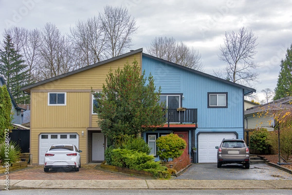 Obraz Duplex residential house with cars parked in front on autumn season in British Columbia