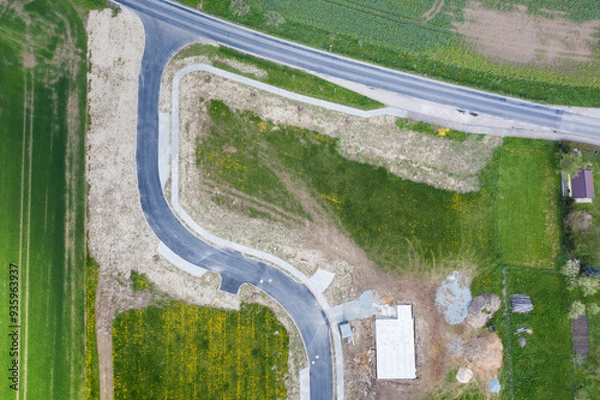 Fototapeta Aerial view of construction site with new roads. Family houses as example of real estate development in suburbs.  Construction of residential houses in the microdistricts. Space for text. Cityscape