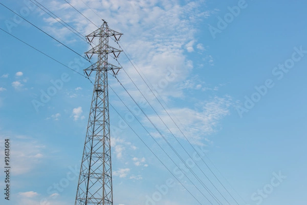 Fototapeta Mast electrical power line against cloud and blue sky.