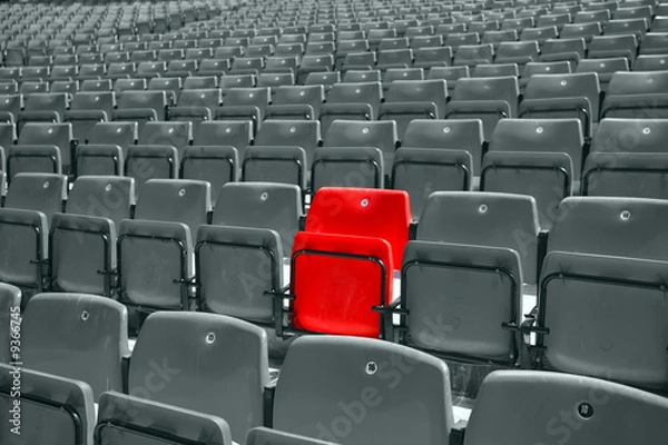 Fototapeta black and white picture of stadium seat with only one red