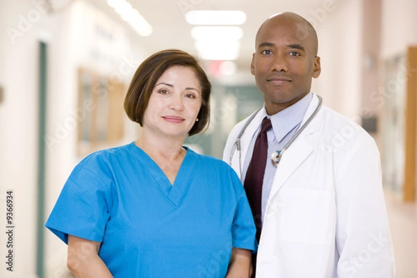 Fototapeta A Doctor And Nurse Standing In A Hospital Corridor