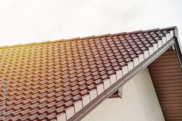 Fototapeta Modern Roof Design with Geometric Shingles Highlighted by Natural Light for Architectural Inspiration and Construction Projects