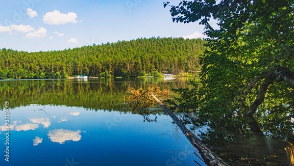 Fototapeta The natural landscape. View of Lake Inyshko, the mountains on the horizon and the forest