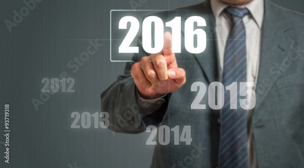 Fototapeta Business Man Touching An Imaginary Screen And Choosing 2016 Year