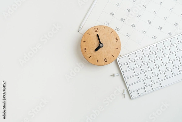 Fototapeta close up of calendar, keyboard and clock on the white table background, planning for business meeting or travel planning concept