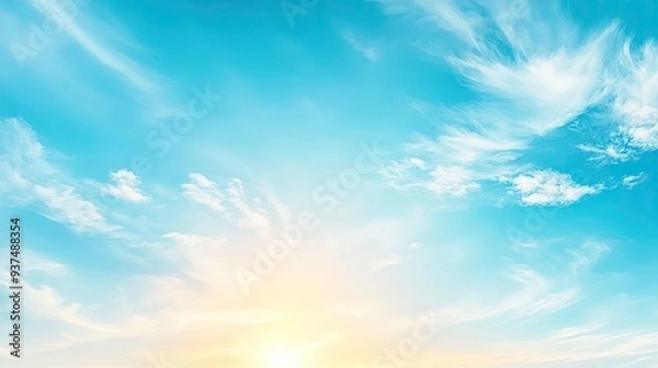 Fototapeta A beautiful blue sky with wispy clouds and a bright sun illuminating the tranquil atmosphere.