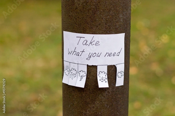 Fototapeta handwritten ad with weather icons and text "Take what you need" on the pillar