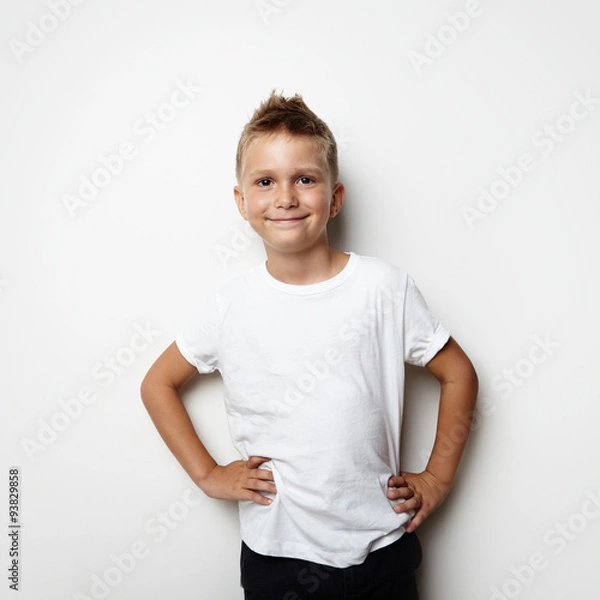 Obraz Smiling boy wearing white tshirt and shorts on the blank wall