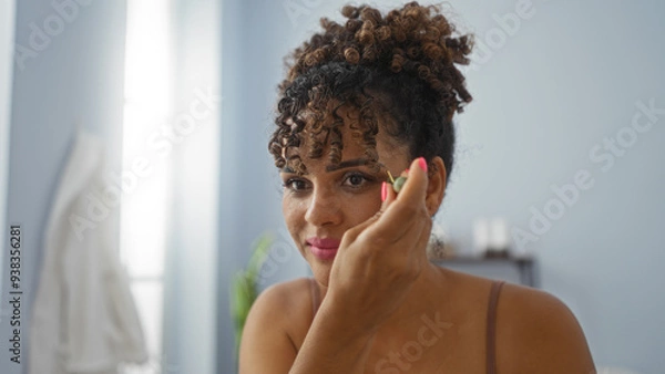 Fototapeta Woman applying makeup at beauty salon, indoor setting, focusing on personal grooming and wellness in an elegant and serene environment.