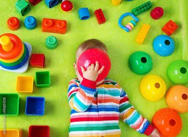Obraz Baby boy lying on the blanket with many toys around