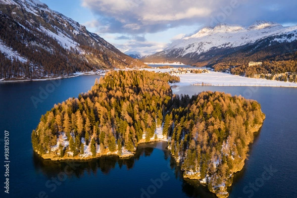 Fototapeta Lake Sils, Switzerland: Dramatic aerial view of the sunset over the Silsersee lake in winter in the Engadine valley in Canton Graubunden in the Swiss alps.