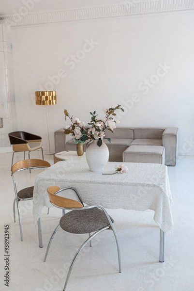 Fototapeta bright interior design of spacious living room with white walls and decorative unique historical moldings on ceiling stylish modern furniture in warm colors without people daylight through the windows