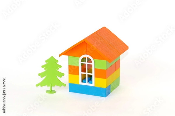 Fototapeta House with green tree made of plastic bricks. Isolated on white background