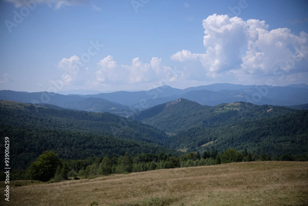 Obraz Expansive mountain range under a bright blue sky view