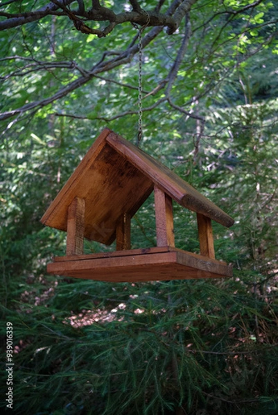 Obraz Wooden bird feeder hanging in forest, side view
