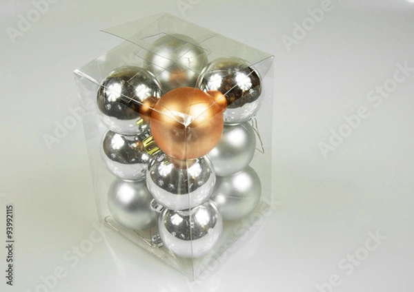 Fototapeta Christmas baubles in a box on a white background.Horizontal.