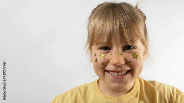 Fototapeta Smiling little girl with stars painting on cheeks mockup