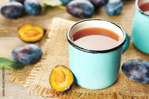 Fototapeta Plum Juice in mugs with fresh fruits