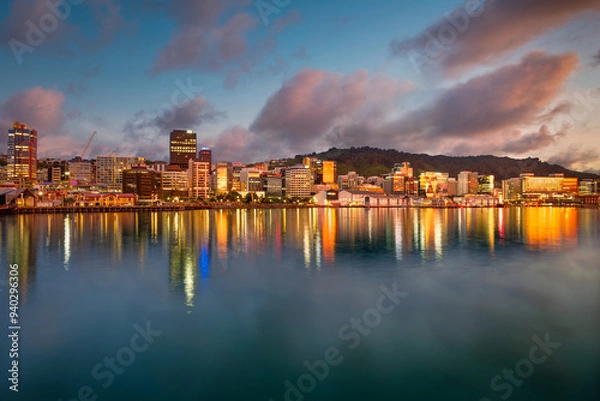 Obraz Downtown Wellington New Zealand, central city buildings reflected in the harbour at sunrise with a blue sky and warm toned clouds.